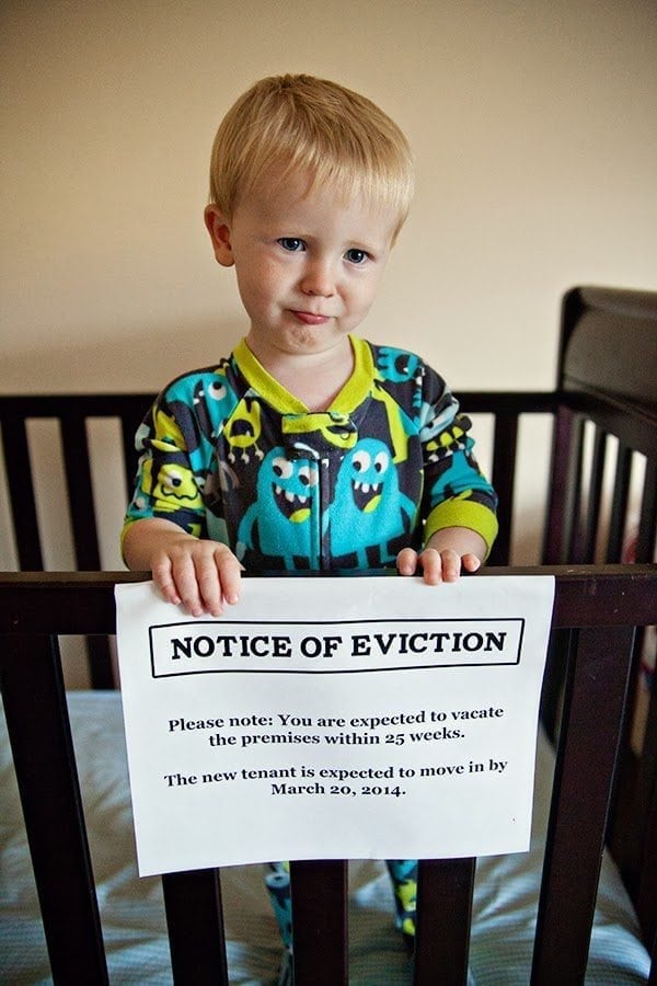 Pregnancy Announcement - Baby Eviction Notice on Side of Crib