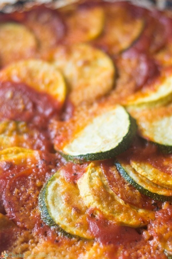 An easy squash tian recipe that is layered with zucchini, yellow squash, spaghetti sauce, parmesan cheese, and optional pepperoni! The perfect summer side dish!