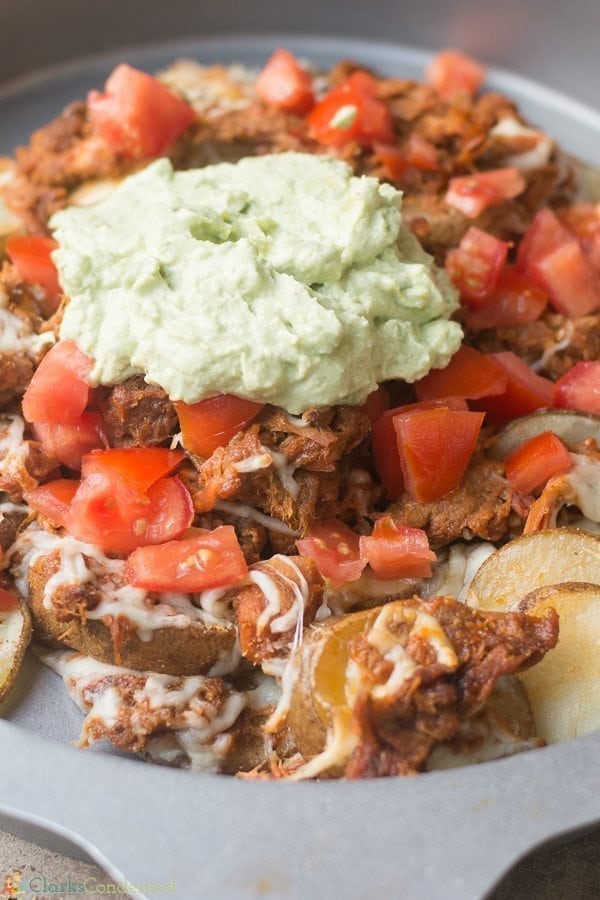 These loaded pulled pork potato nachos are so yummy, and they are the perfect football watch party recipe!