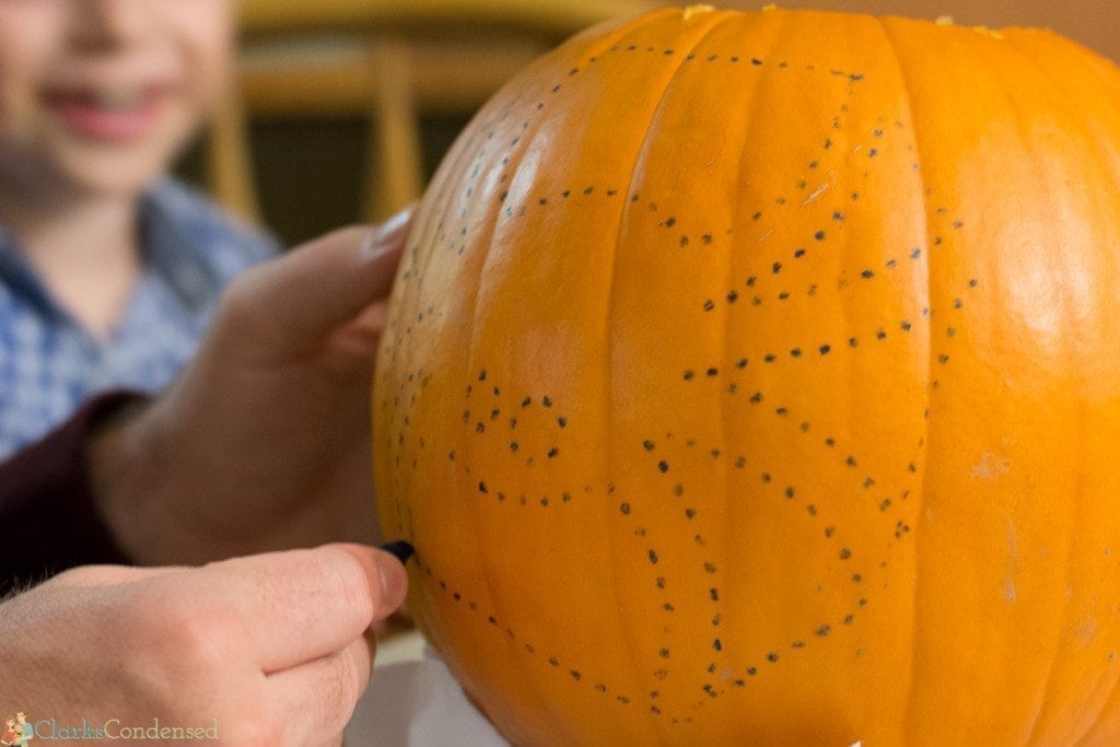 drawing with crayon on pumpkin