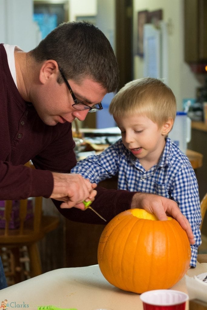 father and son carving pumpkins