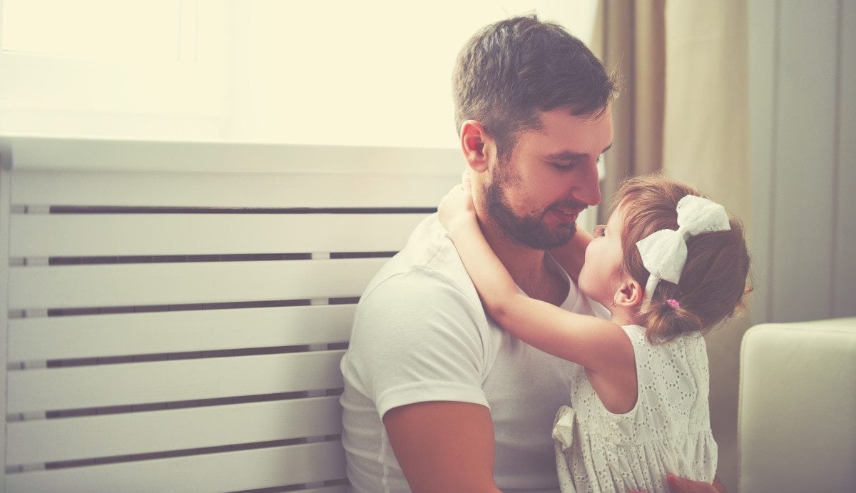 happy family child baby girl in the arms of his father at home window