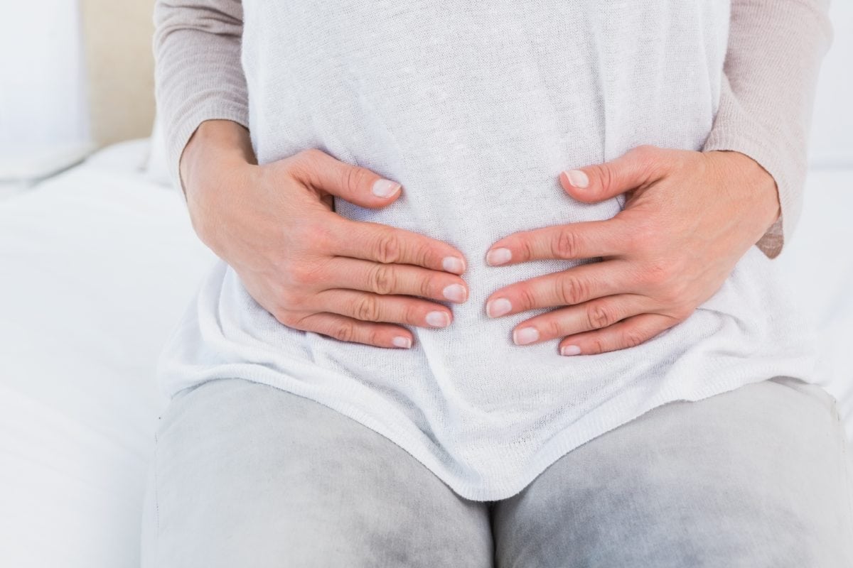 woman with hand on stomach