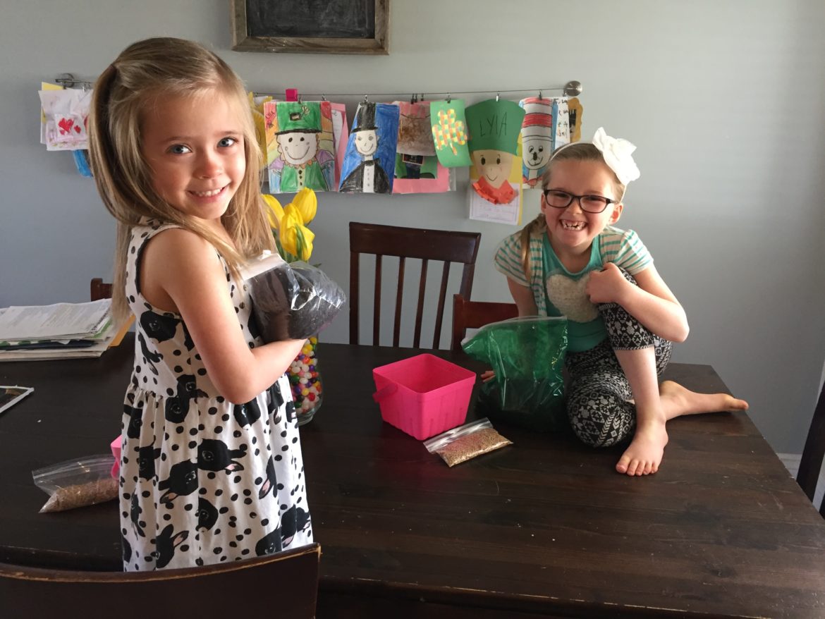 A little girl sitting on a table