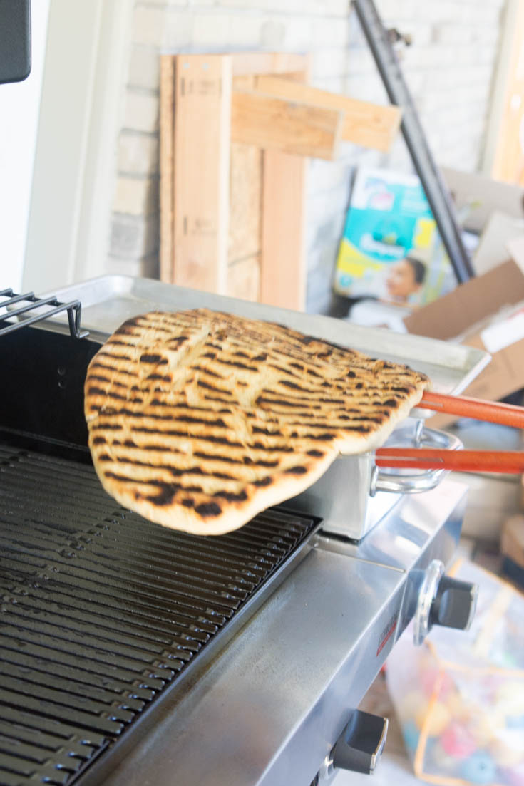 grilled pizza with tongs