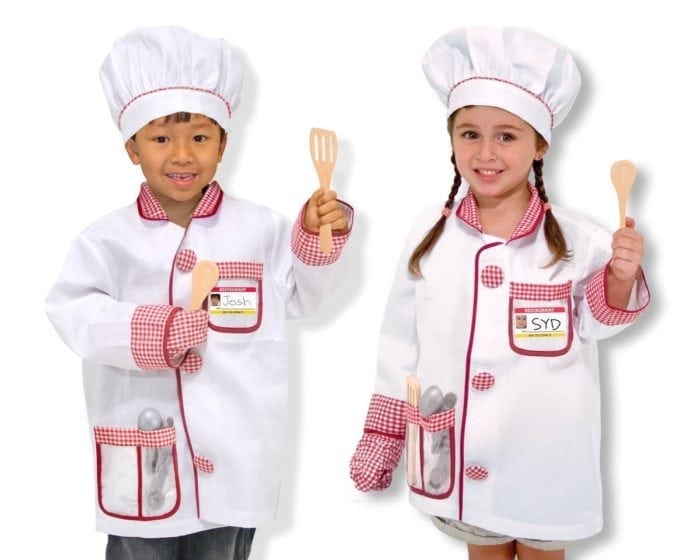 Two kids cooking wearing a chef hat