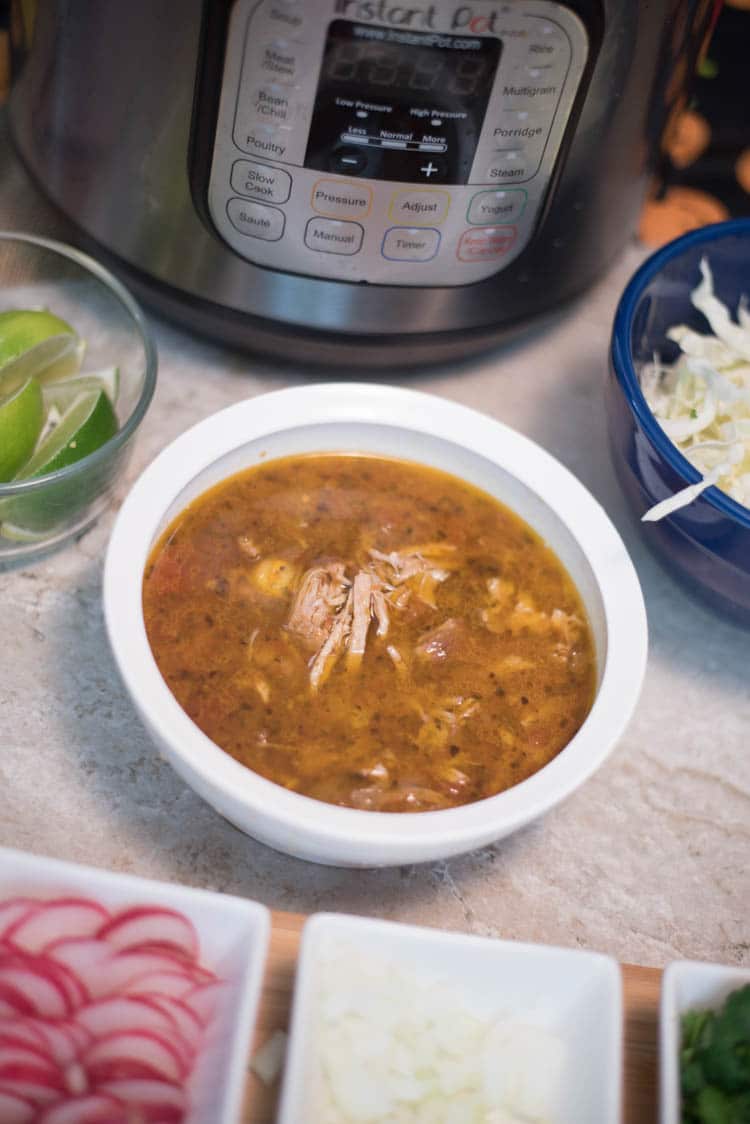 A bowl of food on a table, with Soup