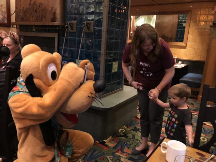 A group of people sitting at a table in disneyland