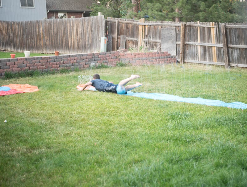Boy sliding down slip-n-slide