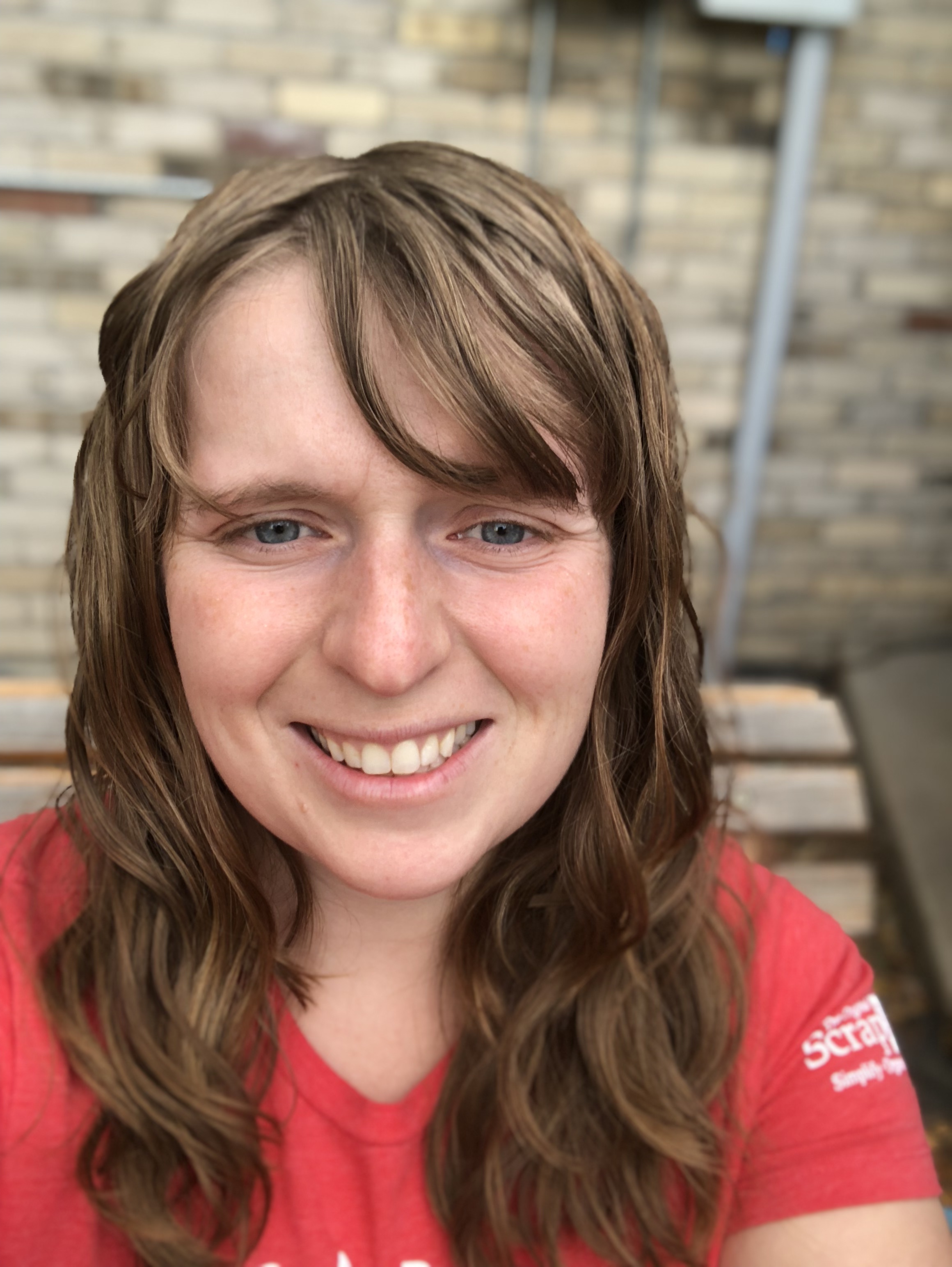 A woman smiling for the camera, with Curly Girl Method