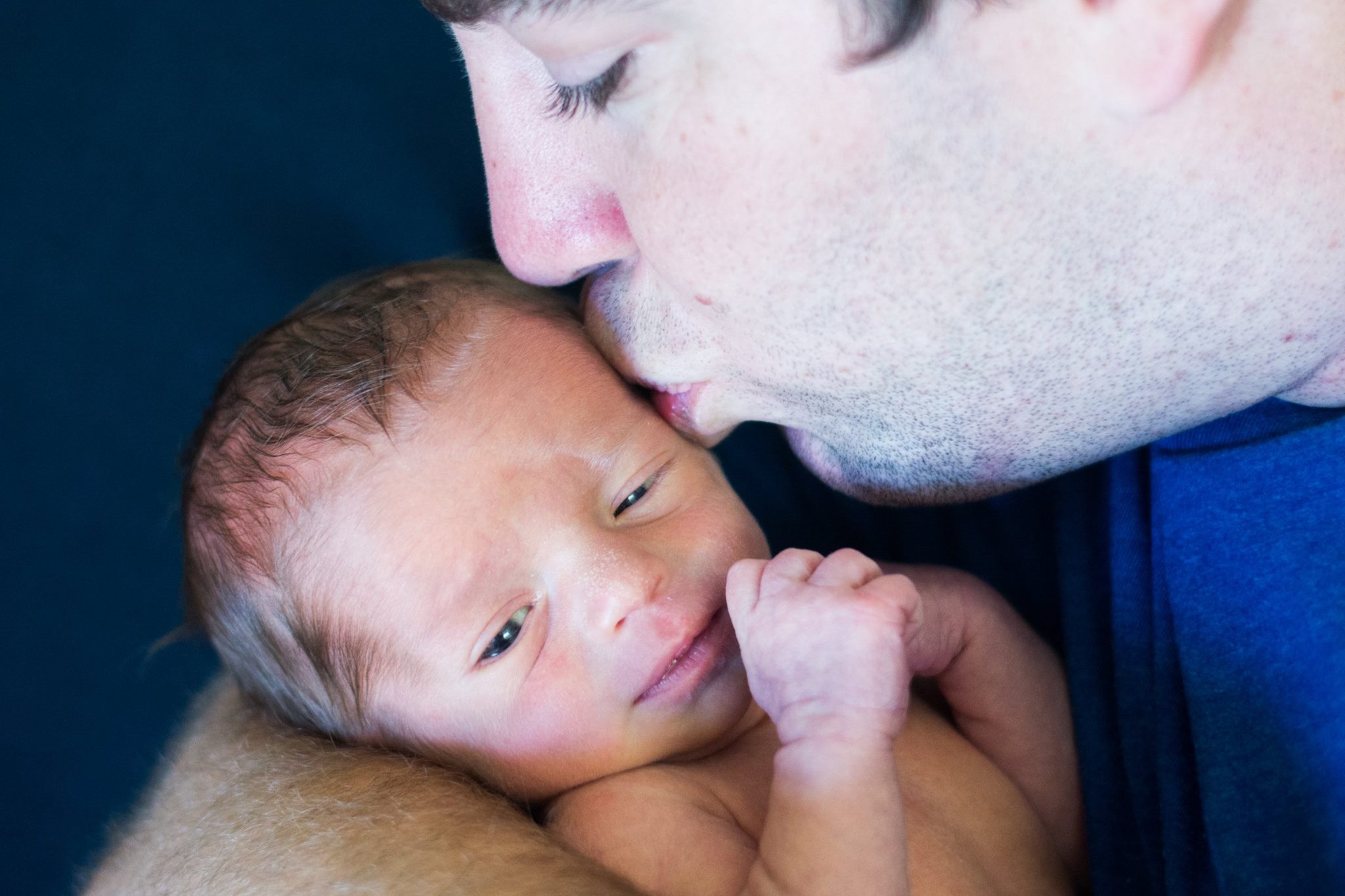 A close up of a man holding a baby