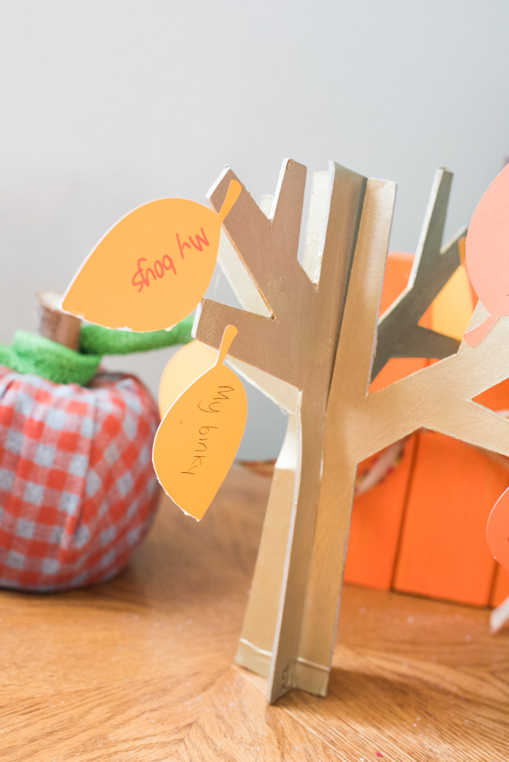 A wooden decorative tree on a table