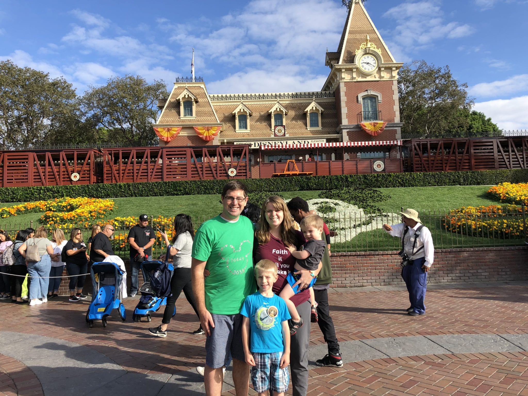 family in front of Disneyland