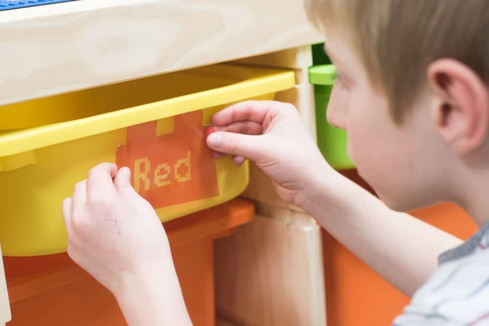 child placing label on box