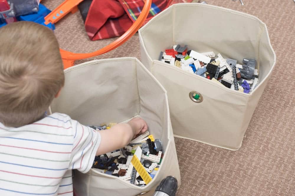 child digging through lego bin
