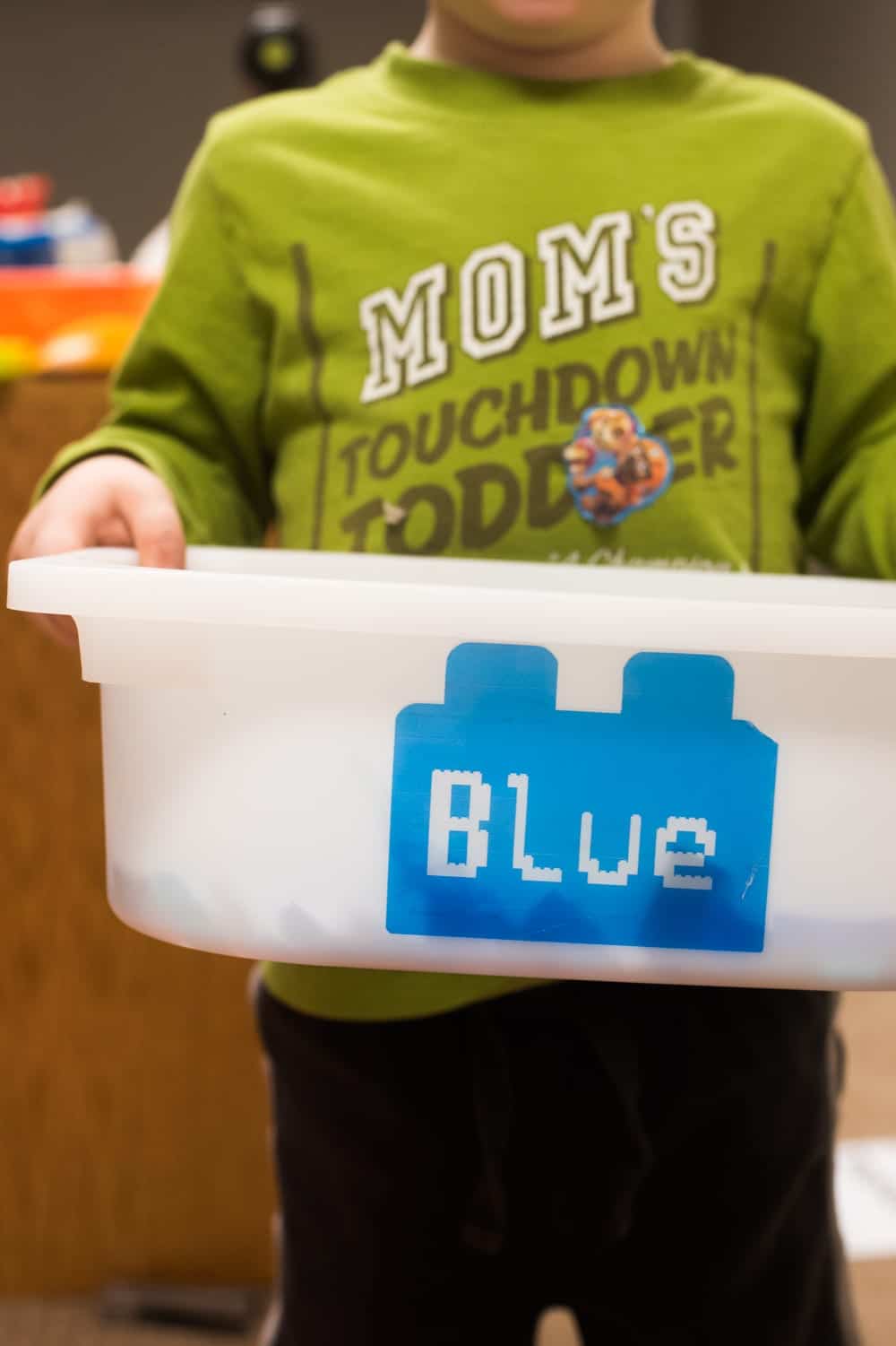 child holding lego box