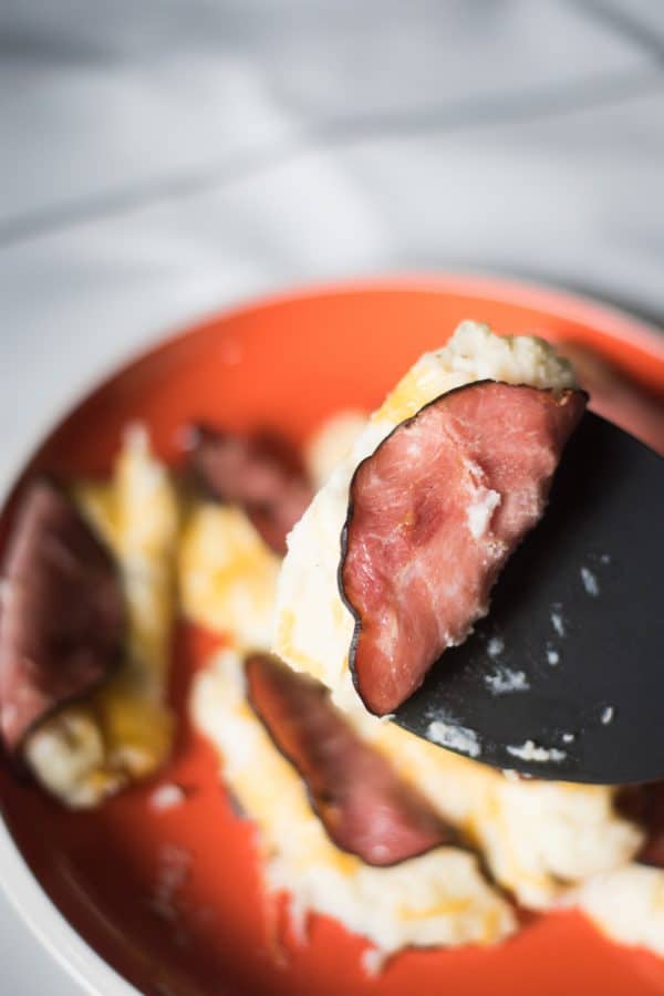 A close up of food on a plate, with Ham and Potato