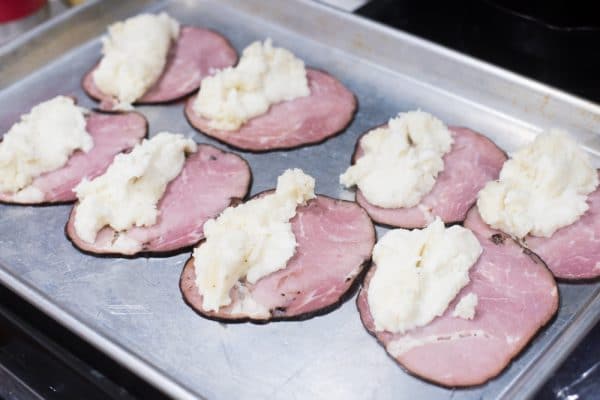 A tray of food on a grill, with Ham and Potato