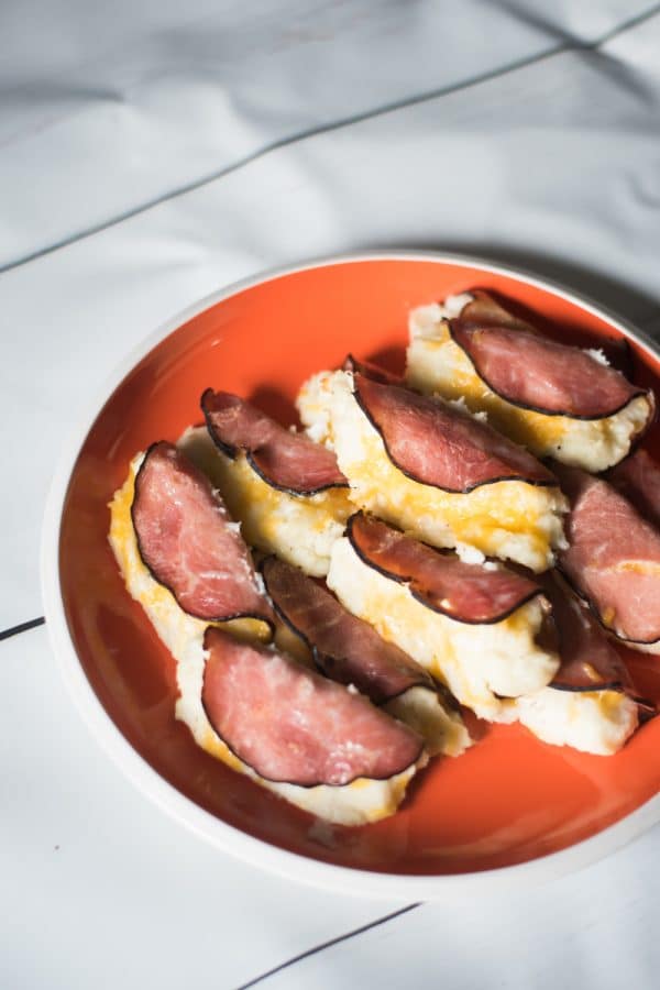 A plate of food on a table, with Ham and Potato