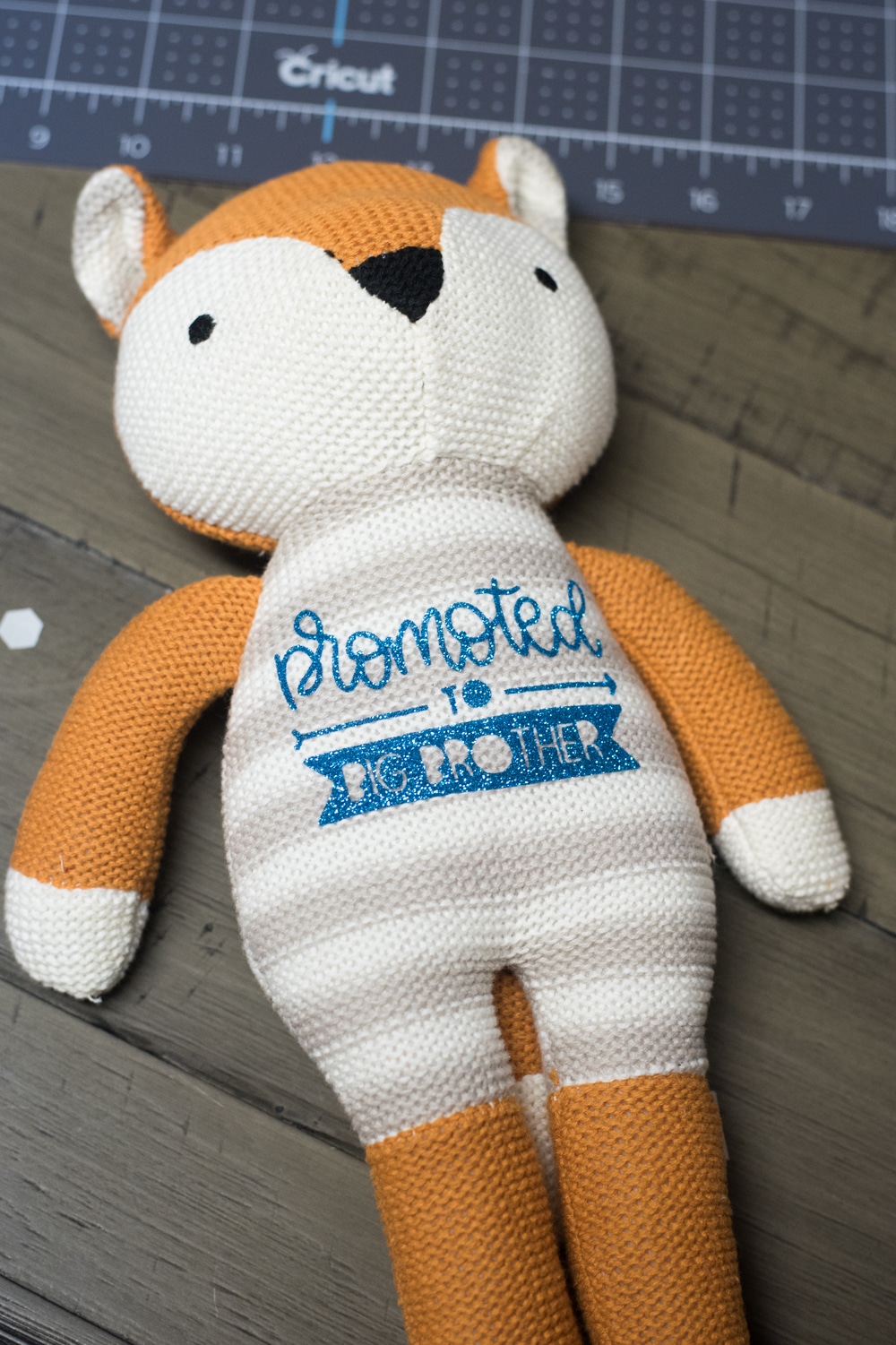 stuffed knit fox with "promoted to brother" on the front