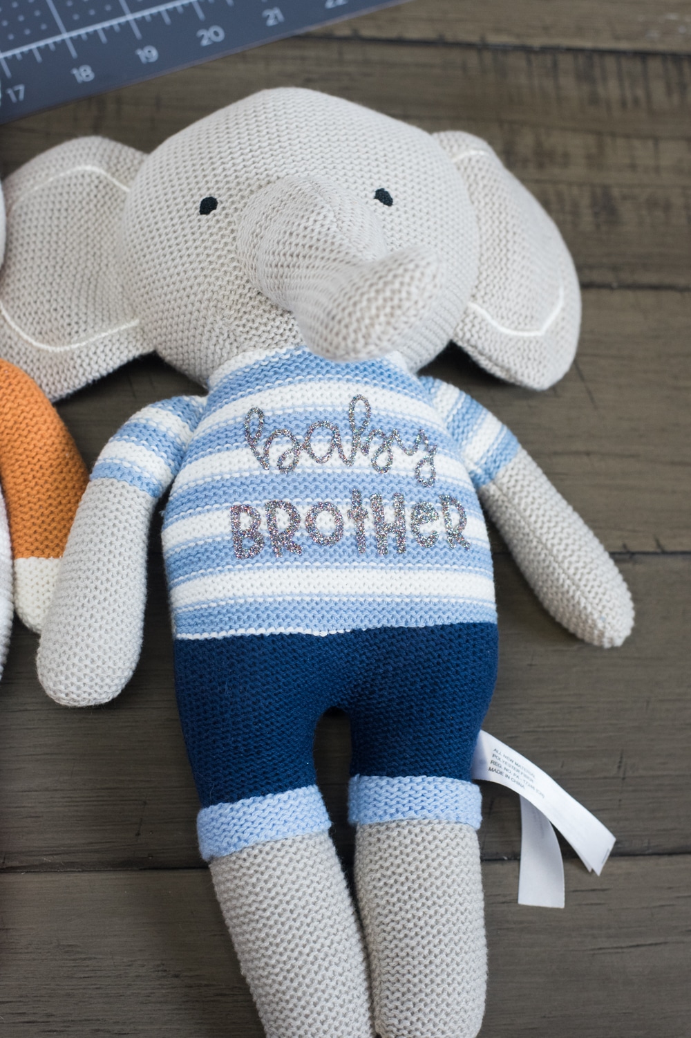 stuffed knit elephant with baby brother on the front in silver
