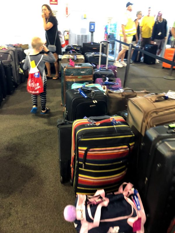 A bag of luggage sitting on top of a suitcase