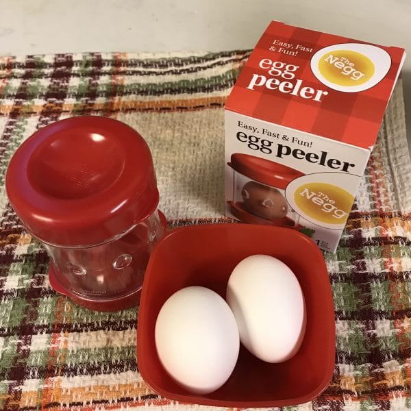 A close up of eggs on a table next to a cup of coffee