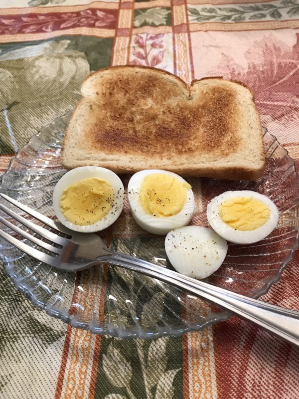 A plate of eggs with a slice of bread