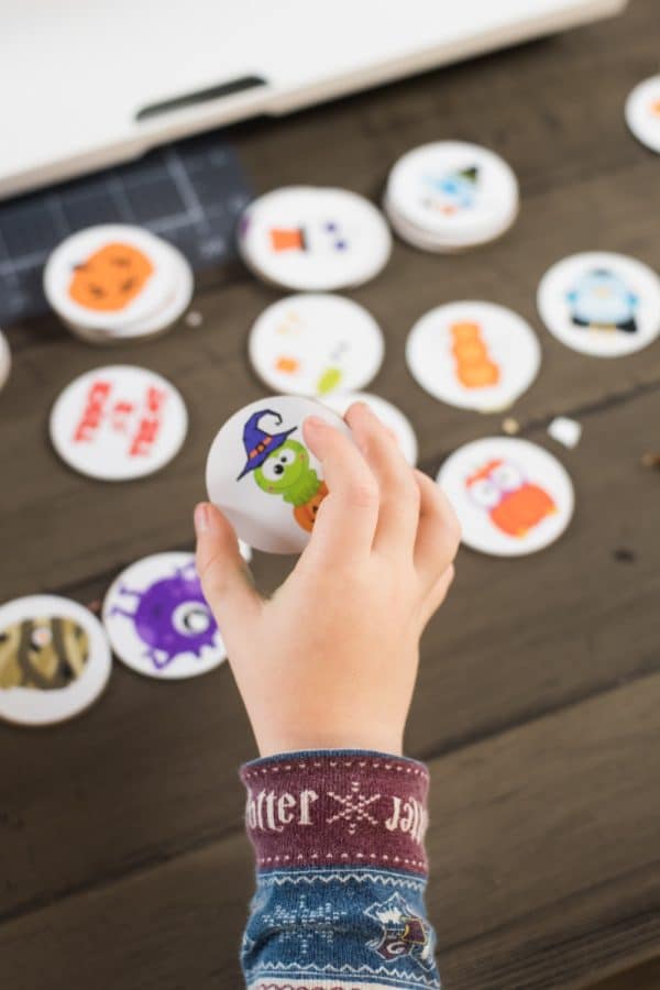 child holding a matching game piece