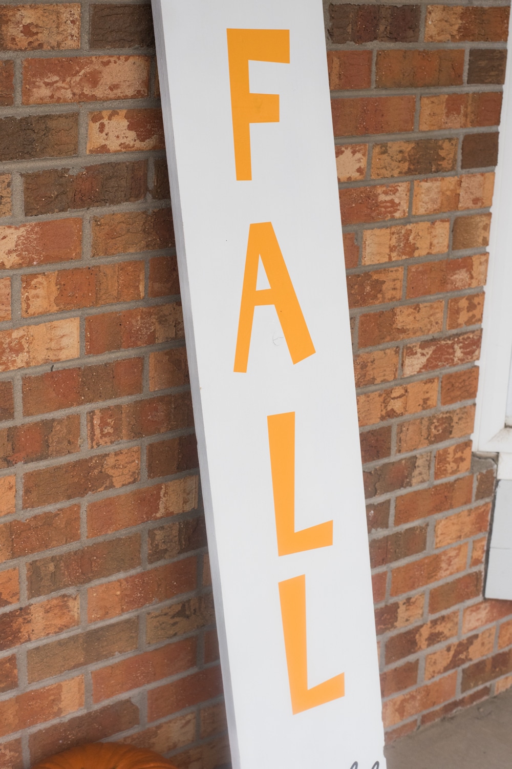 A sign in front of a brick building