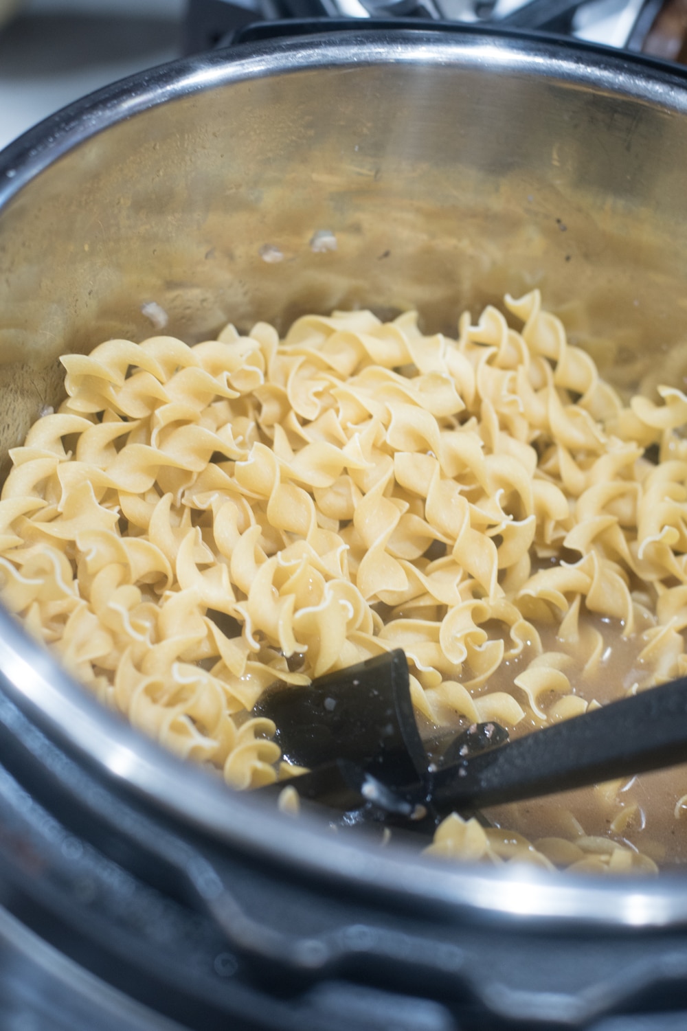 A bowl of food on a metal pan, with Pasta