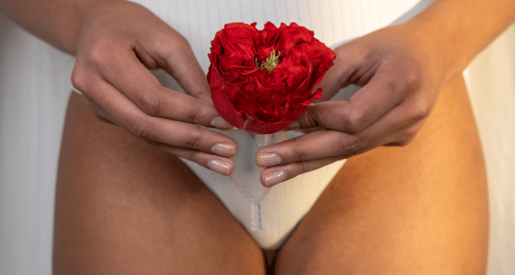 woman with flower and menstrual cup