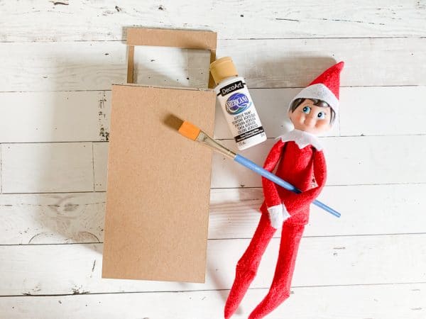 Elf near a cardboard box