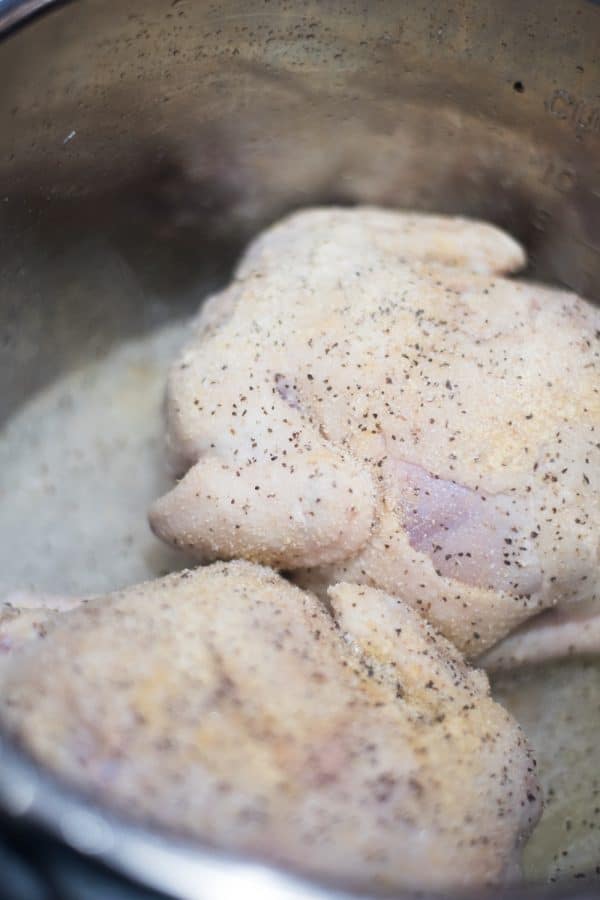 A close up of food in a pan, with Chicken and Cornish game hen