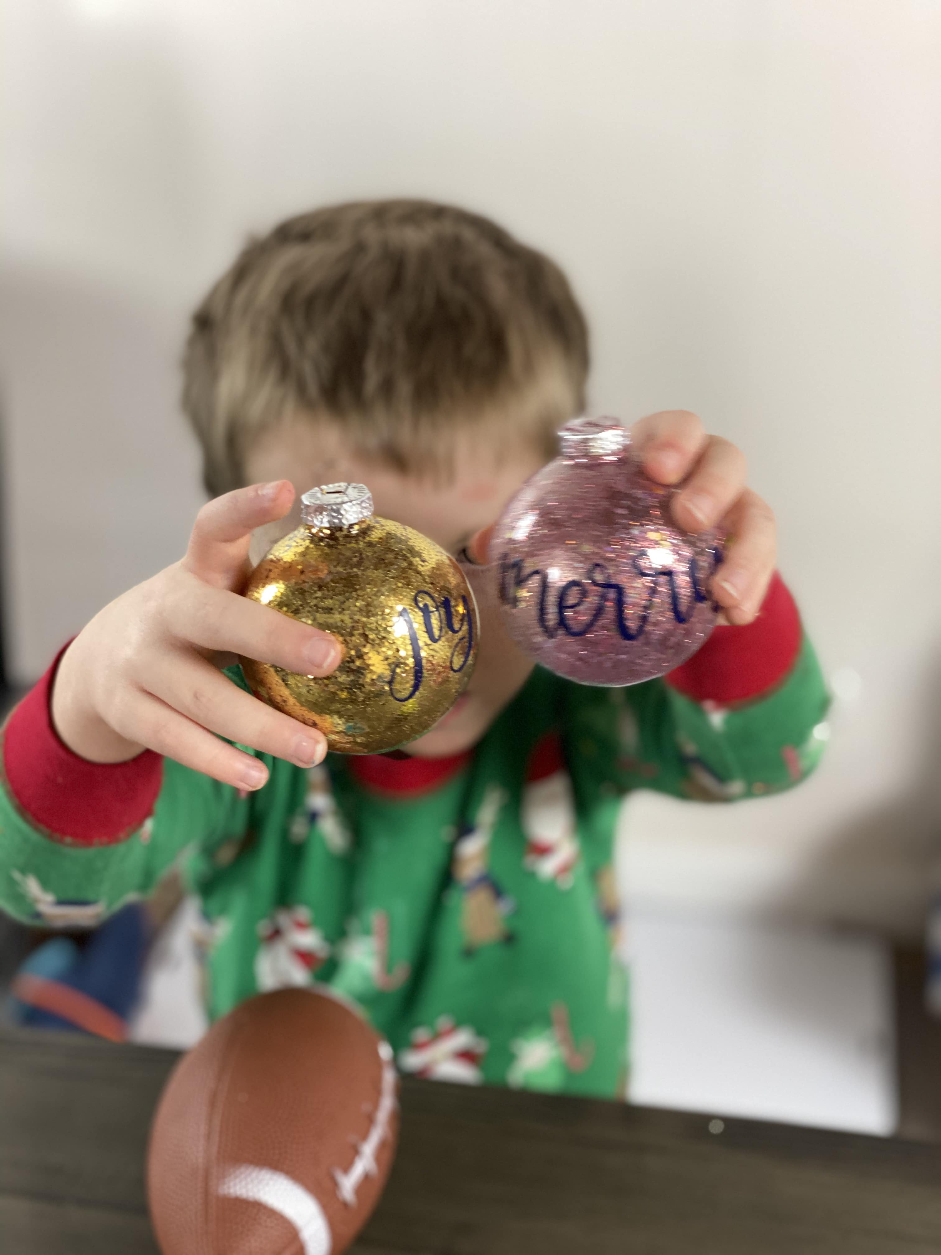 Christmas Glitter Ornament held by little boy