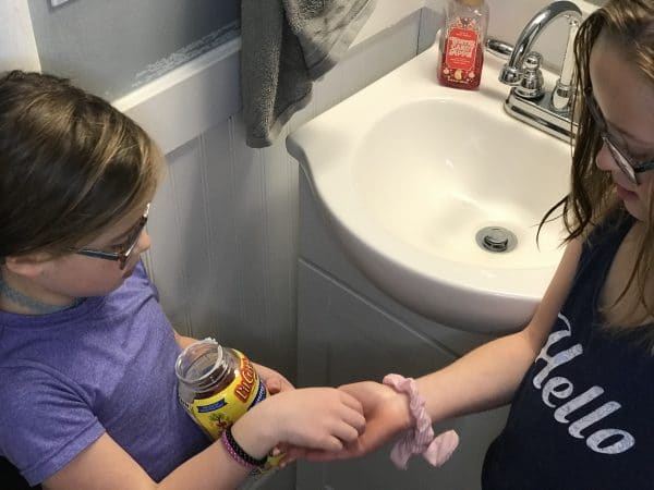 A woman sitting near a sink