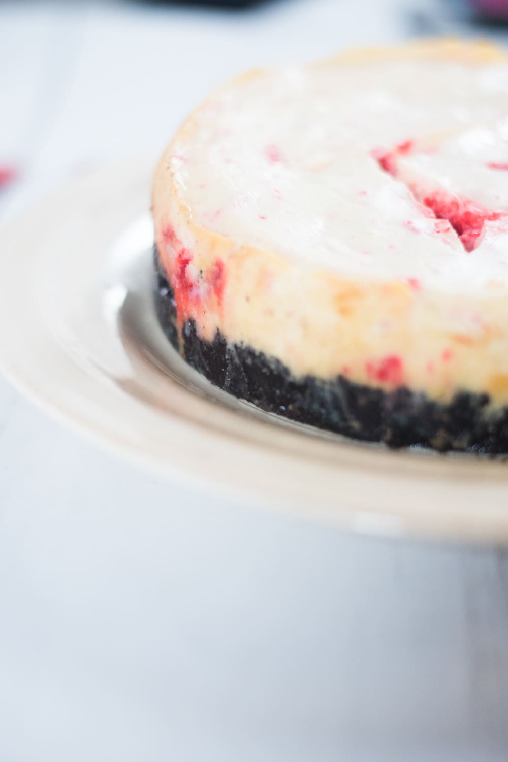A close up of a piece of cake on a plate, with Cheesecake and Peppermint