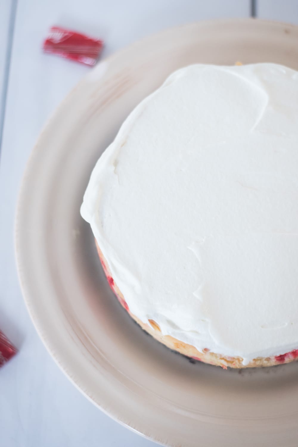 A piece of cake on a plate, with icing