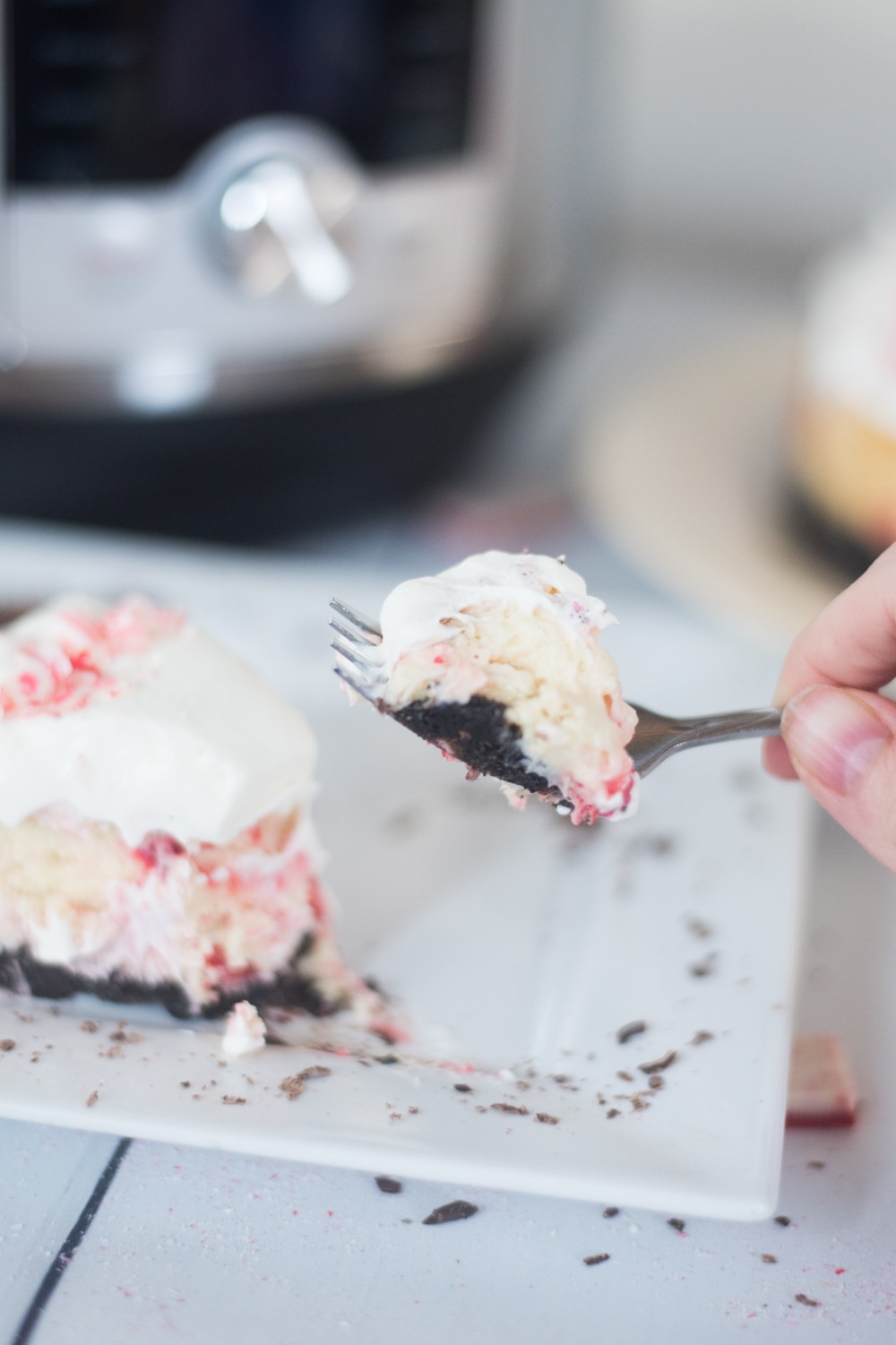 A piece of cake on a plate, with Cheesecake and Peppermint