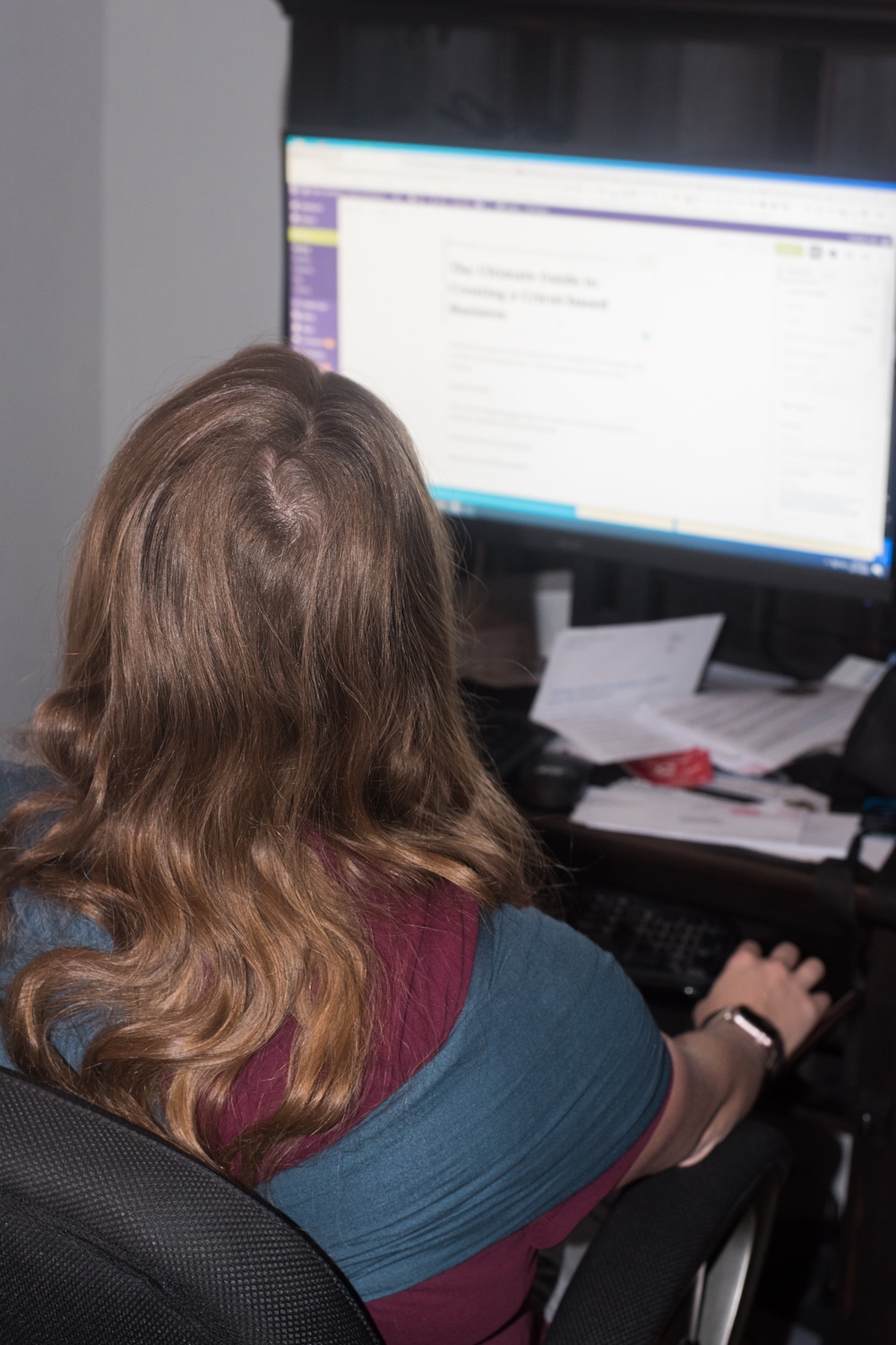 A person sitting at a desk in front of a computer