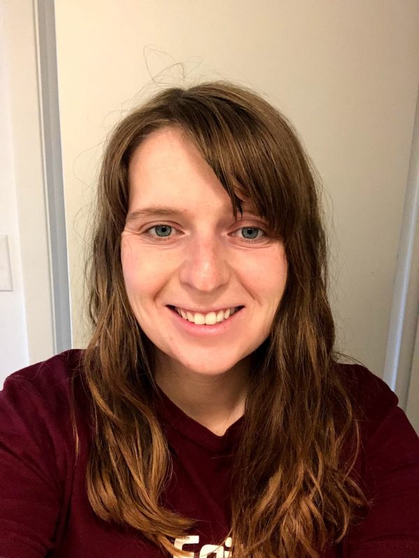 A person smiling for the camera, with Curly Girl Method