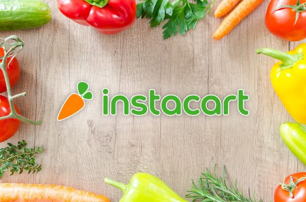 Fresh fruit and vegetables on a cutting board, Instacart logo