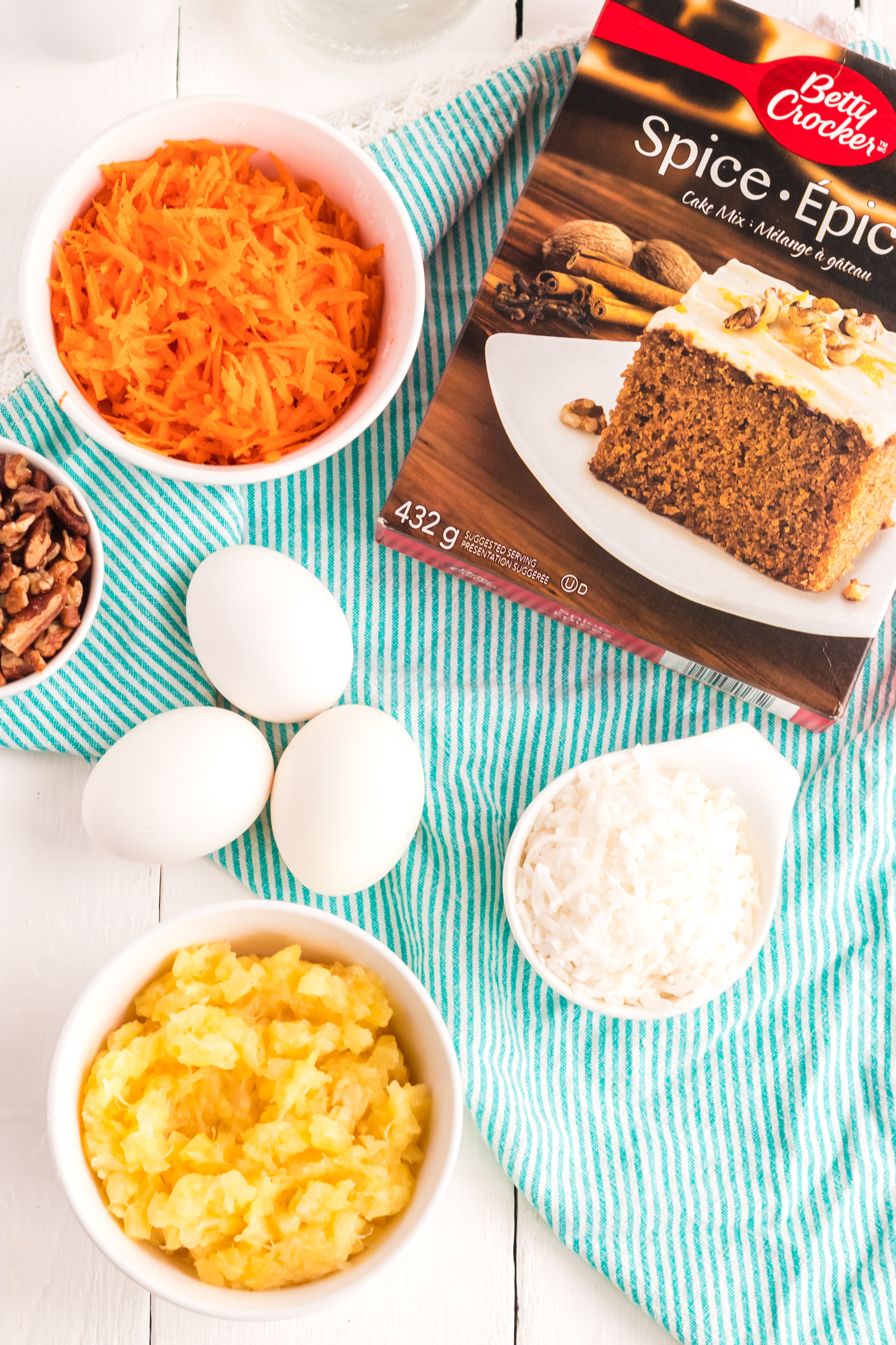 A bowl of food on a plate, with Cake and Carrot