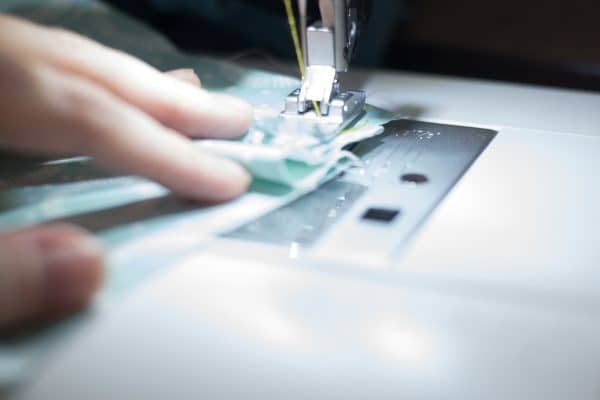 A person sewing a face mask