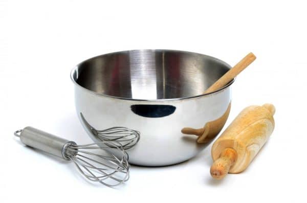 metal bowl with whisk and rolling pin