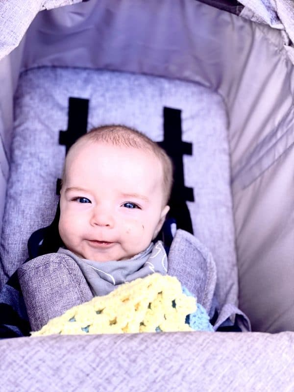 A baby sitting on a bed