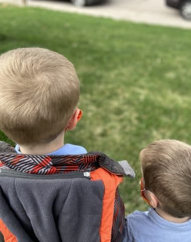 two boys stand on filed