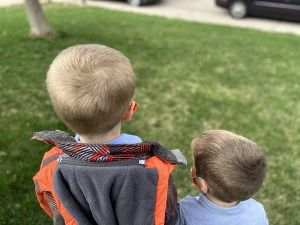 A little boy that is standing in the grass