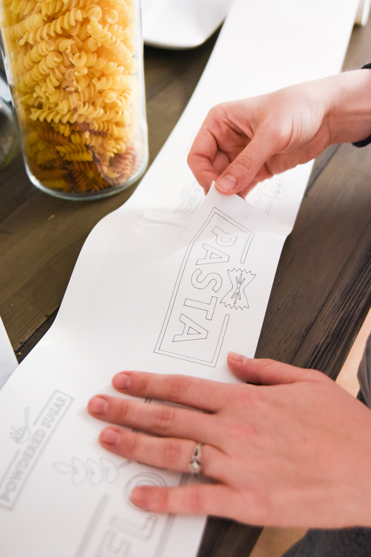 woman peeling label from sheet