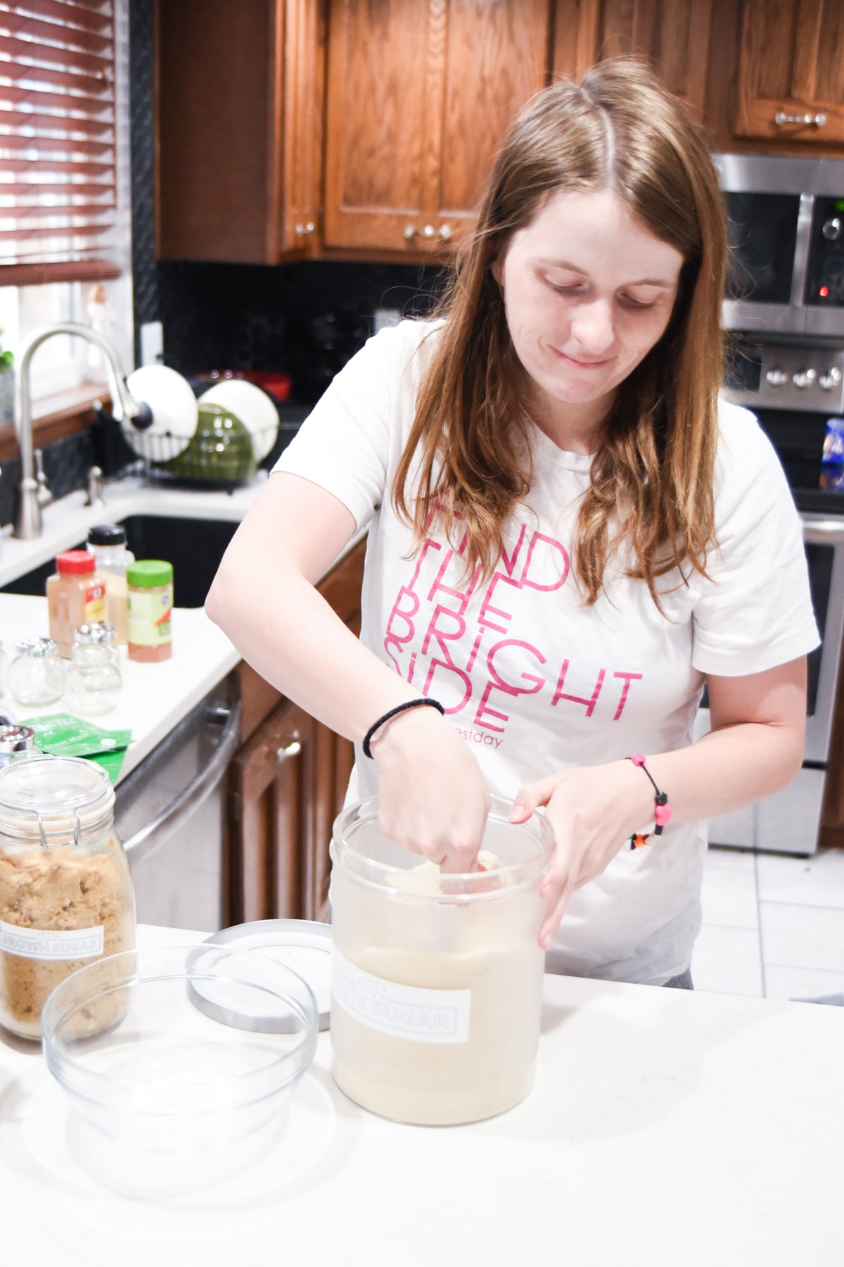 A woman preparing food in a kitchen, with Cricut and Label